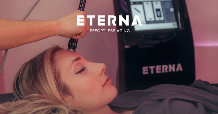 Woman Receiving Eterna Treatment to her forehead with the eternal logo and "effortless aging" in white text